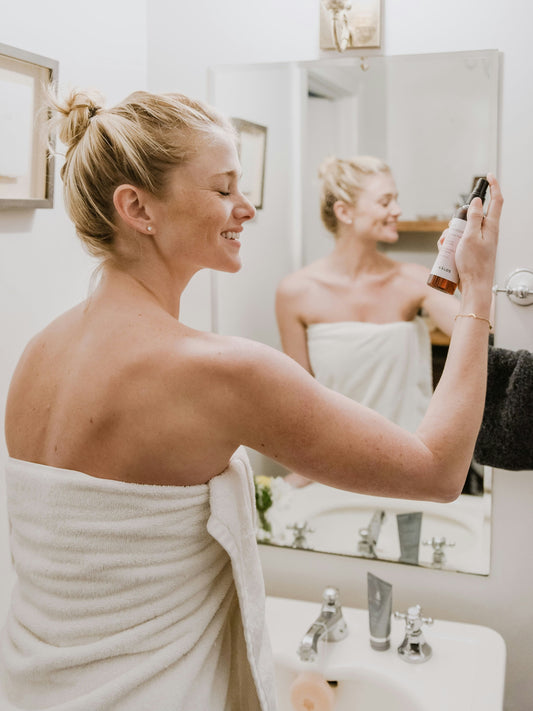 a beautiful doing her skin care in a bathroom